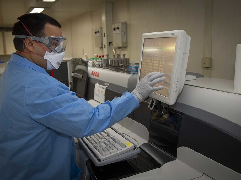Laboratory technician operating test equipment